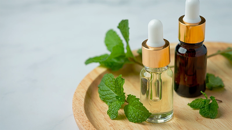 photo of peppermint essential oils on the top of a wooden plate  peppermint essential oil bottle with cooling effect