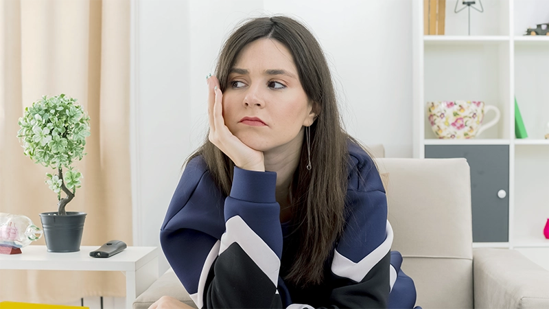 photo of a woman unmotivated sitting in the living room