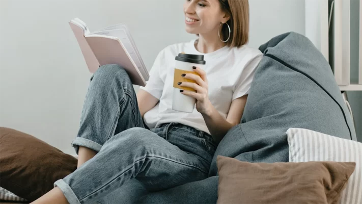 Photo of a happy relaxing while reading