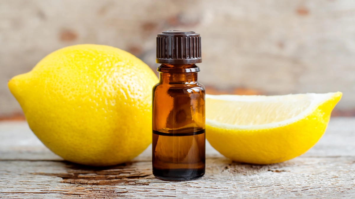 Fresh lemons with lemon essential oil droplets