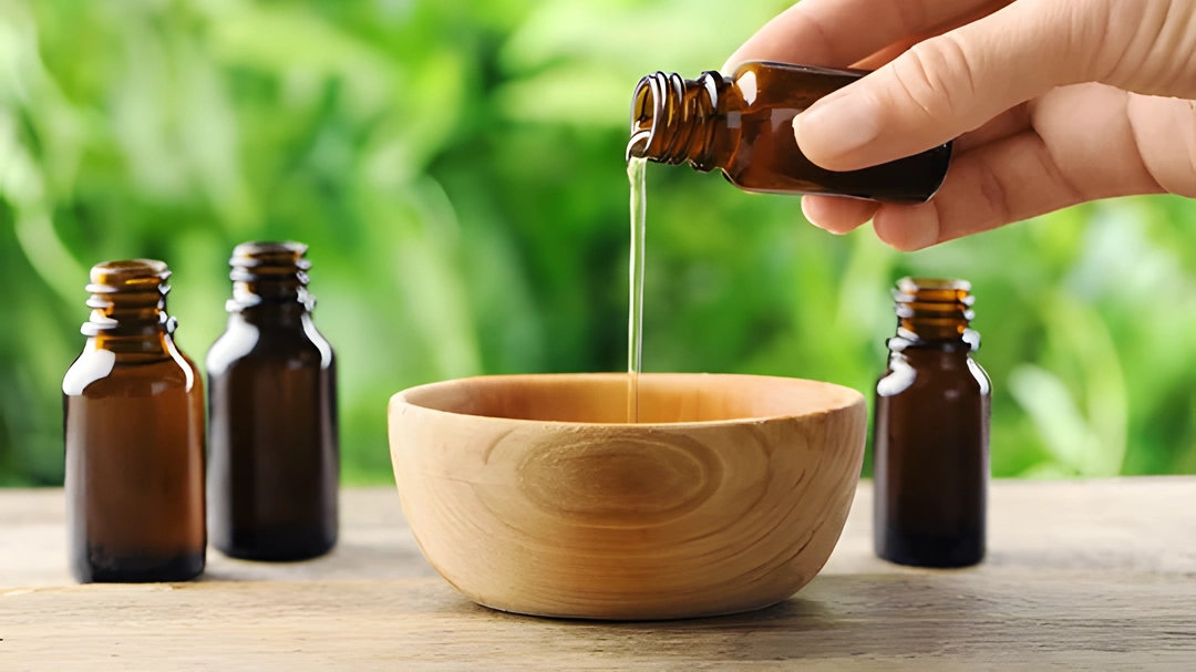 Mixing essential oils and carrier oil in a wooden bowl