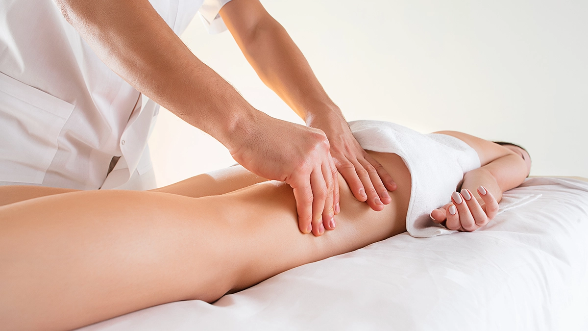 A person receiving a lymphatic drainage massage with essential oils