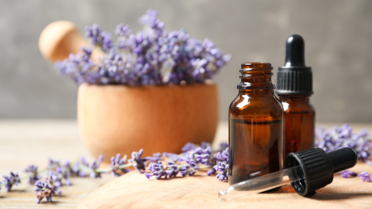 Lavender flowers and a bottle of lavender essential oil for Itchy Skin Calming Relief