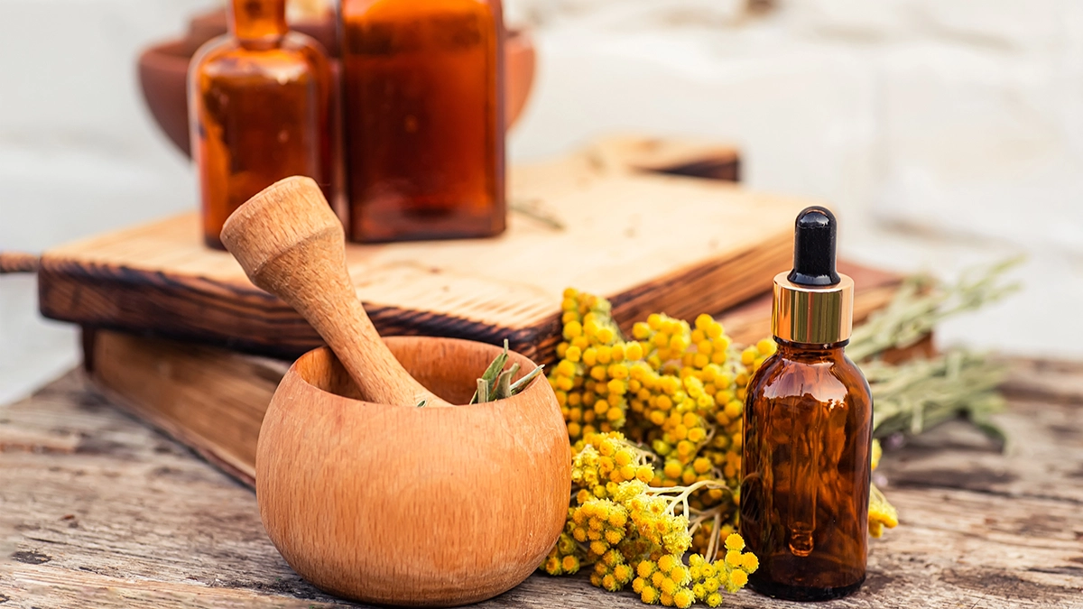 Amber bottles and herbs highlight essential oils' role in natural sun protection