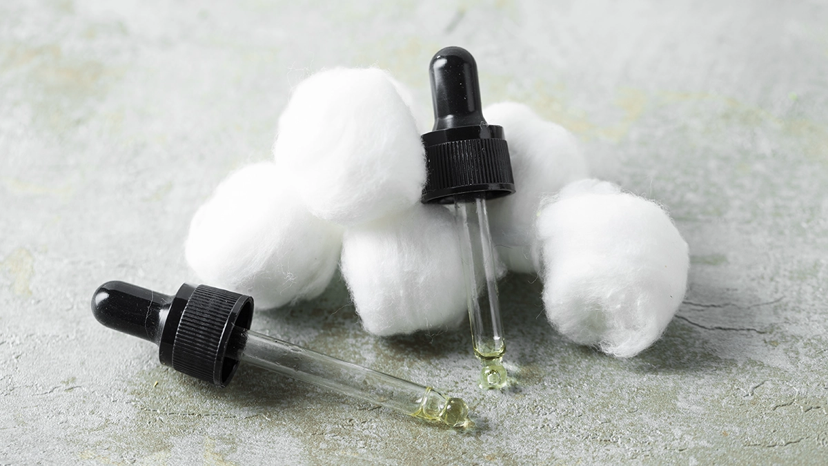 Droppers with essential oils and cotton balls, highlighting their natural use for roach control