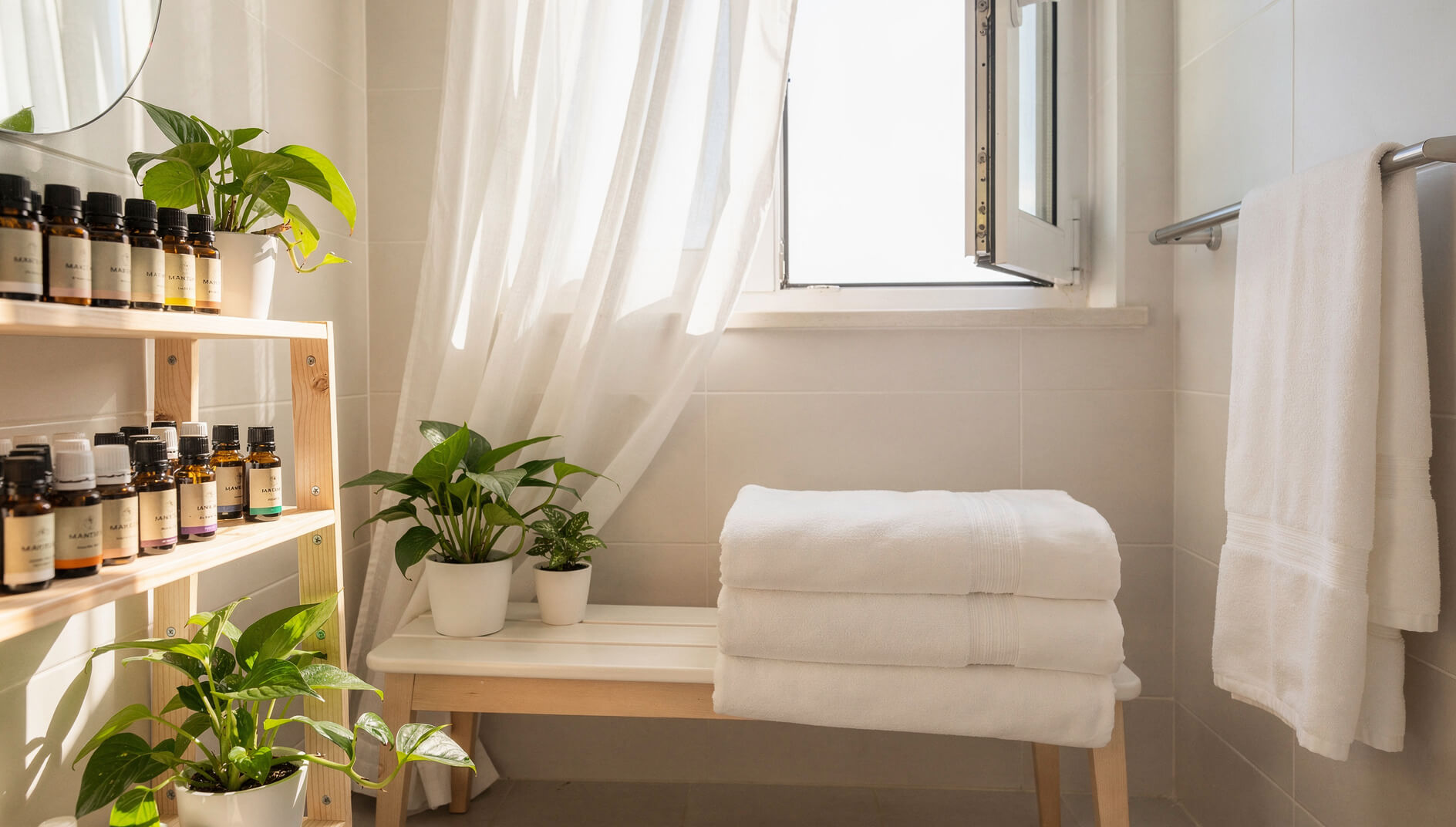 Bright airy bathroom with organized essential oils and natural light